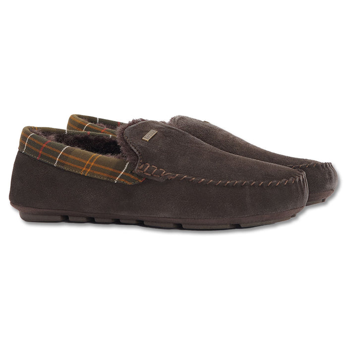 Dark brown suede Barbour Monty slippers with a tartan plaid collar, faux fur lining, and moccasin-style stitching.