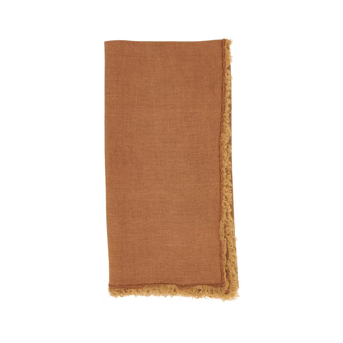 Rust-colored stone-washed linen-cotton napkin with handmade fringed edges, 20x20 inches.