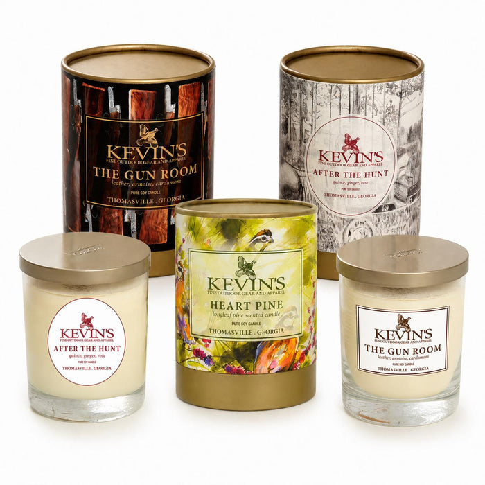 Kevin's soy candles in glass jars and decorative canisters with gold lids, featuring Gun Room, After The Hunt, and Heart Pine.