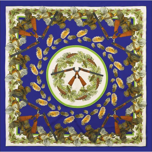 Blue 35-inch silk scarf featuring a Dagmar Cosby quail, shotgun, and pine wreath illustration with hand-rolled hems.