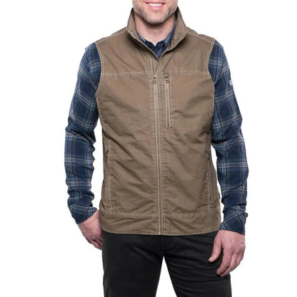 Kuhl men's brown cotton canvas vest with a zip-up chest pocket and stand-up collar worn over a plaid flannel shirt.