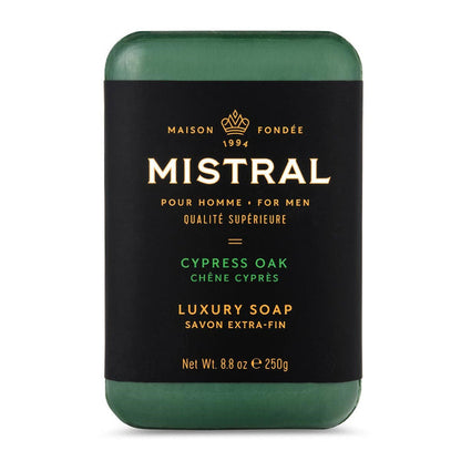 Mistral Cypress Oak men's bar soap in a dark green hue with a black label featuring gold text and a crown logo.