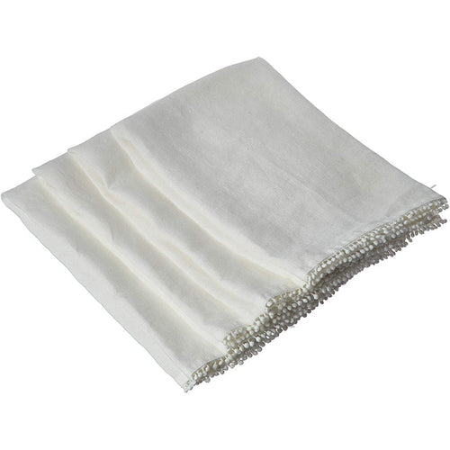 Folded white linen-cotton blend napkin featuring delicate handcrafted pompom trim along the edge.