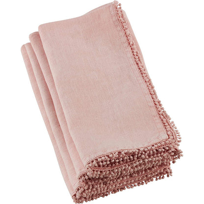 Folded dusty pink linen-cotton blend napkin featuring delicate pompom trim edging for a textured, elegant look.