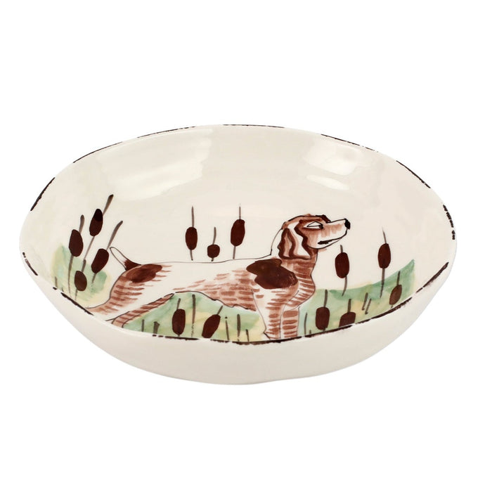 Hand-painted 8.5-inch Tuscan ceramic pasta bowl featuring a whimsical brown dog and cattails on a cream background.