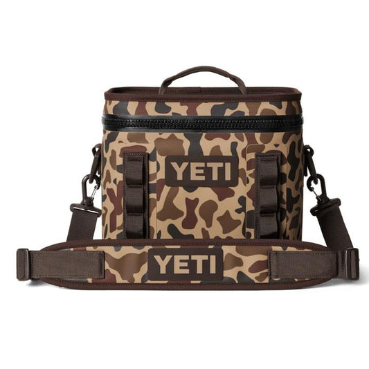 YETI Hopper Flip 8 soft cooler in brown camo print with a durable waterproof shell, top handle, and padded shoulder strap.