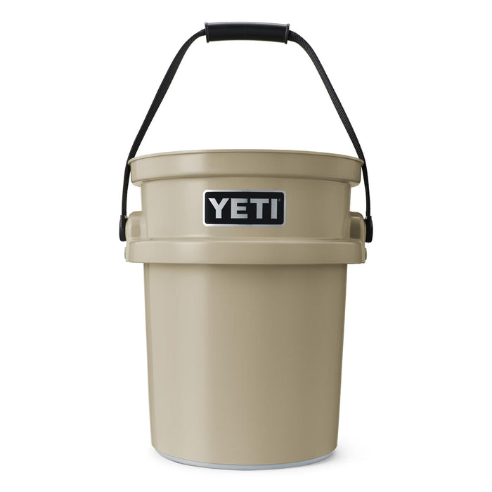 Tan YETI LoadOut 5-gallon bucket made of durable high-density polyethylene with a black handle and logo badge.